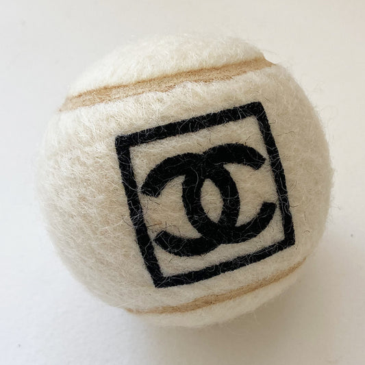 Chanel CC Logo tennis ball from Spring 2008 RTW by Karl Lagerfeld for Chanel. Black interlocking CC box logo printed on ball in excellent unused vintage condition. 