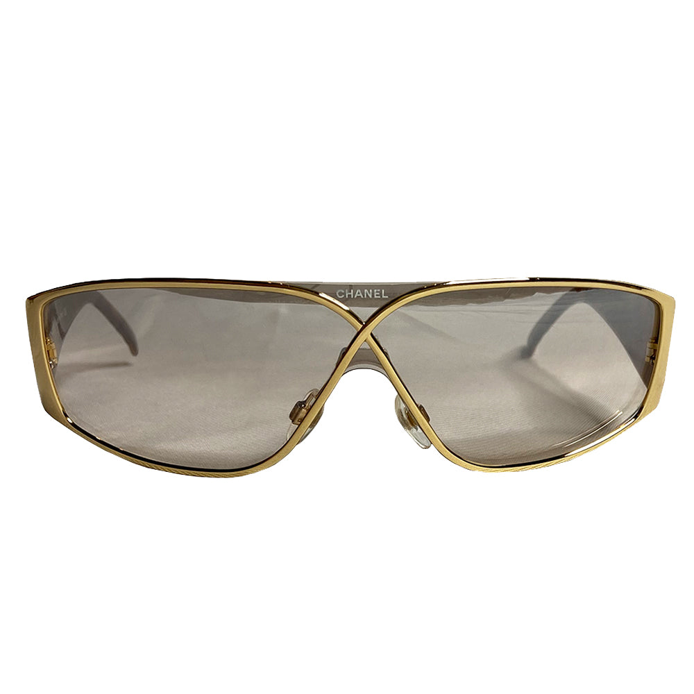 Chanel gold-tone metal frame and thick quilted acetate arms sunglasses by Karl Lagerfeld for Chanel, Infinity shaped design metal frame over shield lens, CHANEL printed on lens at nose bridge with booze lens Style: 4097 Made in Italy