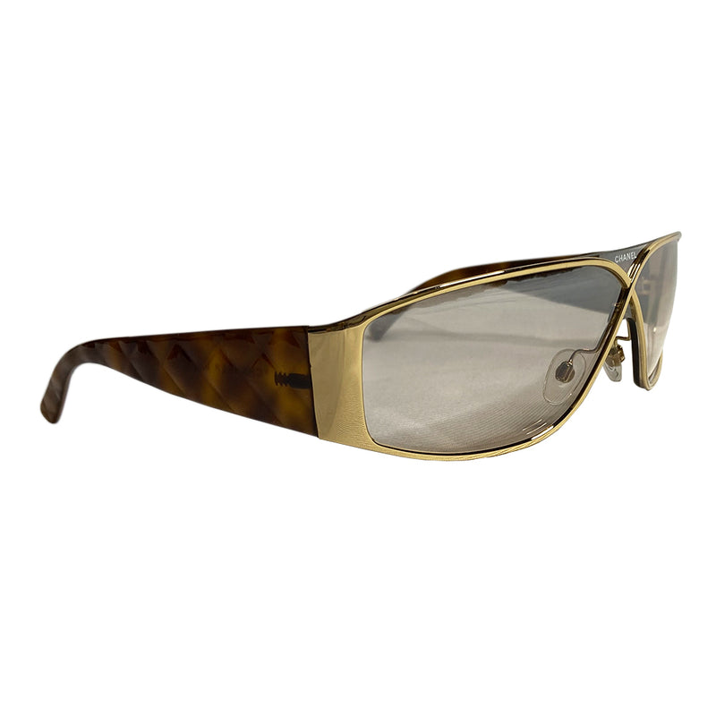 Chanel gold-tone metal frame and thick quilted acetate arms sunglasses by Karl Lagerfeld for Chanel, Infinity shaped design metal frame over shield lens, CHANEL printed on lens at nose bridge with booze lens Style: 4097 Made in Italy