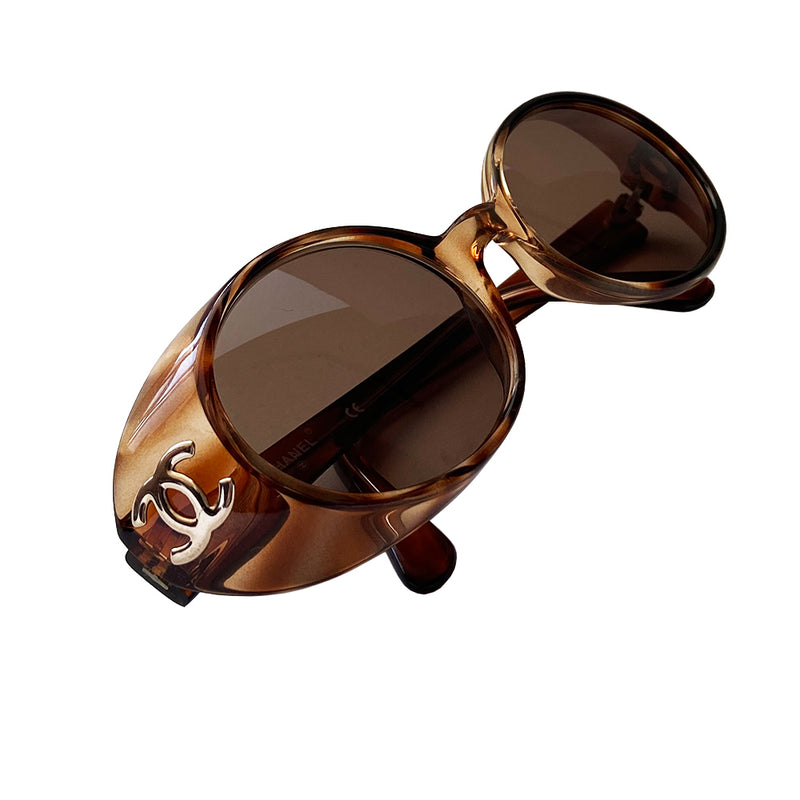 Chanel 1990’s Oval tortoise frame with goggle sunglasses from Karl Lagerfeld for Chanel 1990’s iconic sunglasses. Acetate  frames with dark brown lenses and interlocking CC gold logos at temple. Style: 05976 91235 Case not included. Made in Italy 