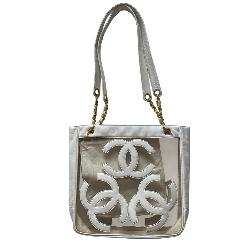 Chanel Triple CC tote by Karl Lagerfeld for Chanel, 1995. Clear vinyl with white lamb leather CC logos, outer edges, leather with gold chain shoulder straps, interior dual gold Chanel engraved magnetic snap closure. Attached leather inner zippered pouch with gold-tone CC logo zipper pull. Interior date code attached. Made in Italy 