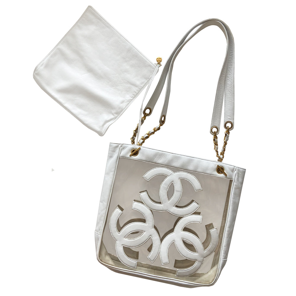 Chanel Triple CC tote by Karl Lagerfeld for Chanel, 1995. Clear vinyl with white lamb leather CC logos, outer edges, leather with gold chain shoulder straps, interior dual gold Chanel engraved magnetic snap closure. Attached leather inner zippered pouch with gold-tone CC logo zipper pull. Interior date code attached. Made in Italy 