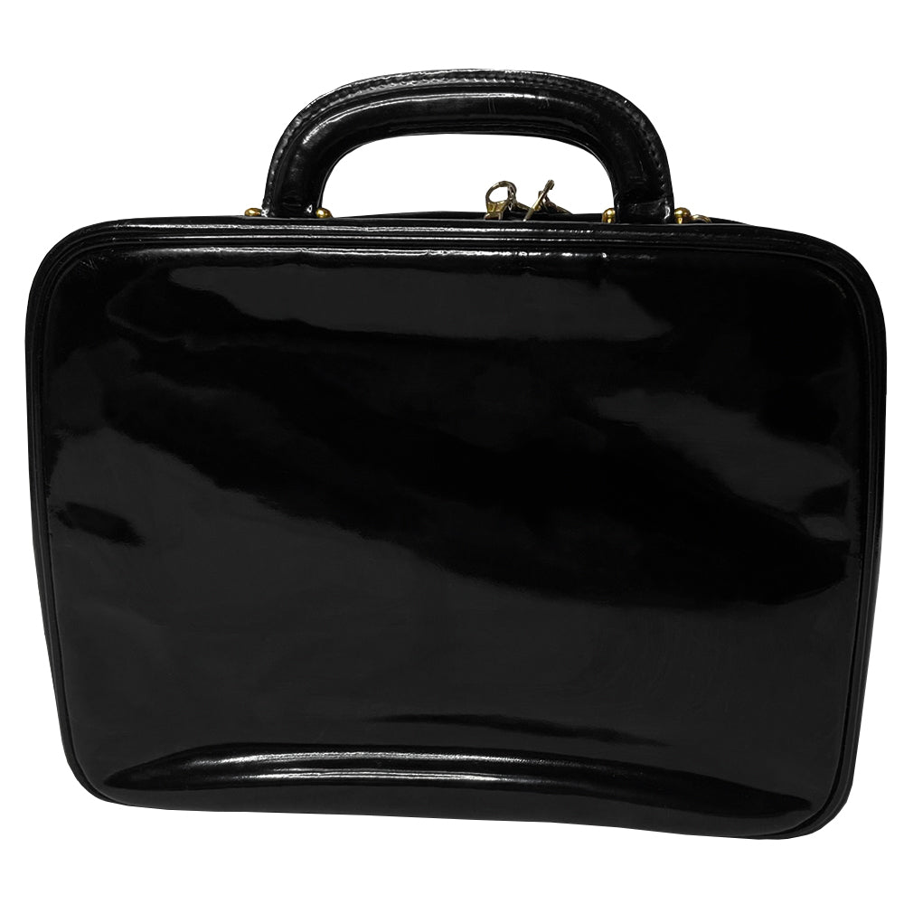 Chanel patent leather vanity case by Karl Lagerfeld for Chanel 1996 with interlocking CC logo at front, dual logo zipper pull closure, top carry handle and removable long strap. Leather interior with inner flap that snaps to side, zippered pocket with logo zipper pull, serial number sticker attached. Made in Italy
