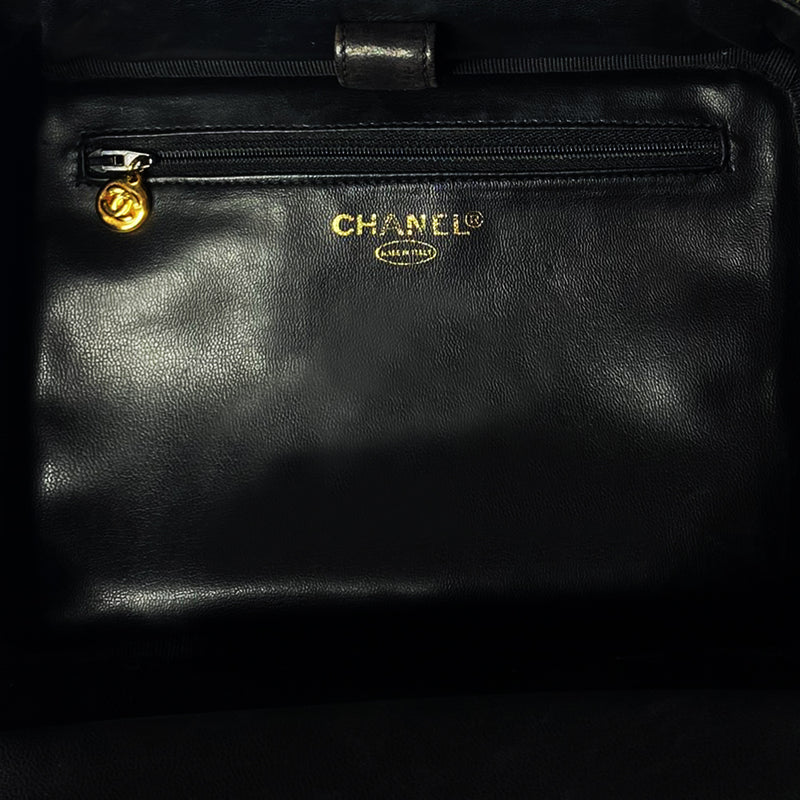 Chanel patent leather vanity case by Karl Lagerfeld for Chanel 1996 with interlocking CC logo at front, dual logo zipper pull closure, top carry handle and removable long strap. Leather interior with inner flap that snaps to side, zippered pocket with logo zipper pull, serial number sticker attached. Made in Italy