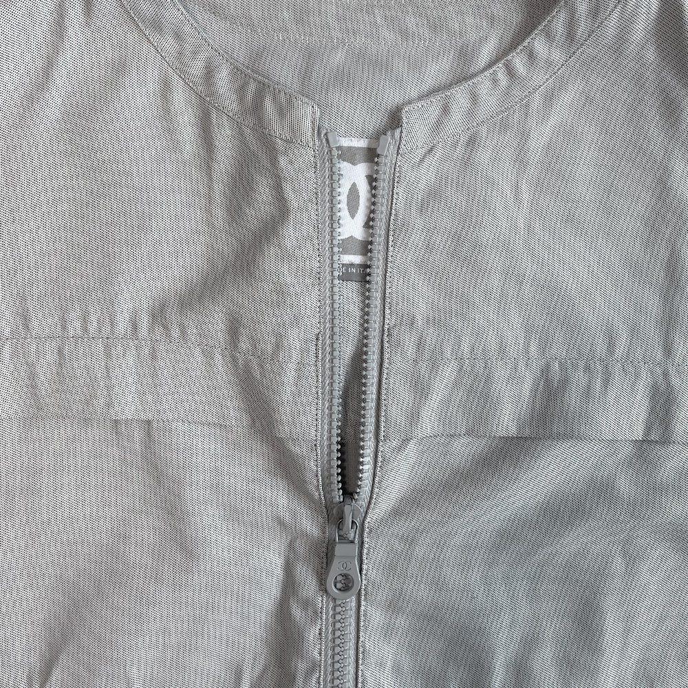 Chanel Identification logo collarless zip front grey vest/top by Karl Lagerfeld for Chanel, spring 2001 with box CC logo appliqué in back, CC logo engraved zipper pull and silver-tone toggles that adjust the elastic cording at bottom hemline. Made in Italy 