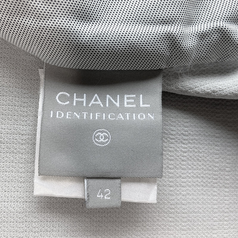 Chanel Identification logo collarless zip front grey vest/top by Karl Lagerfeld for Chanel, spring 2001 with box CC logo appliqué in back, CC logo engraved zipper pull and silver-tone toggles that adjust the elastic cording at bottom hemline. Made in Italy 