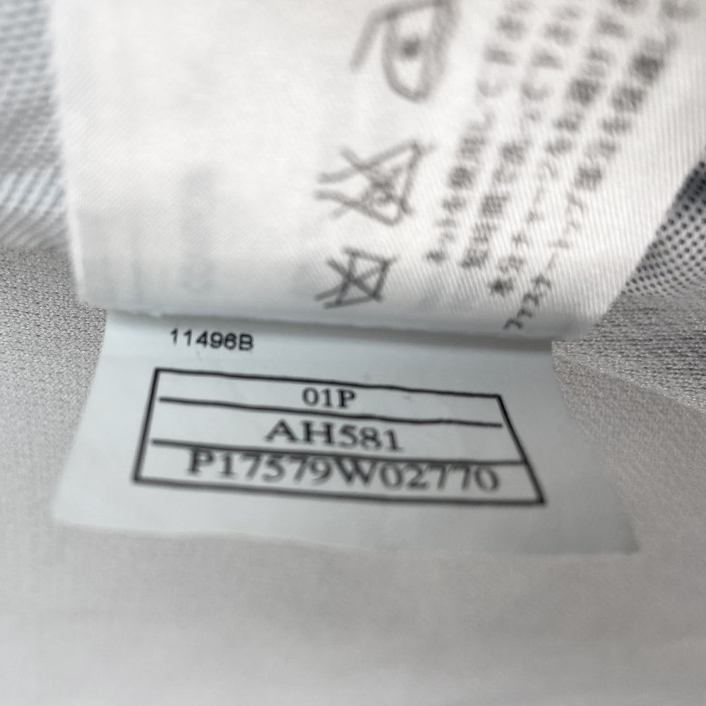 Chanel Identification logo collarless zip front grey vest/top by Karl Lagerfeld for Chanel, spring 2001 with box CC logo appliqué in back, CC logo engraved zipper pull and silver-tone toggles that adjust the elastic cording at bottom hemline. Made in Italy 