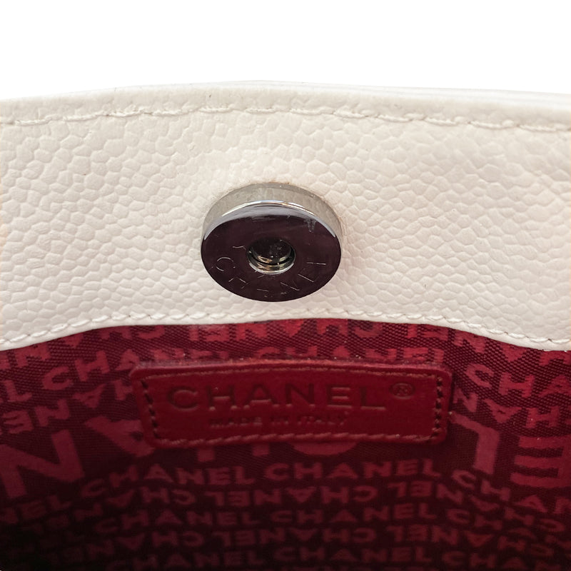 White Chanel Button Chain Quilted Shoulder Bag with 2 Gunmetal front buttons and 2 gunmetal chain link and interwoven leather straps, exterior quilted front pocket.  Magnetic snap button closure, burgundy textile jacquard Chanel lining. Chanel Paris engraved on inside clasp. Interior hologram date code tag attached. 