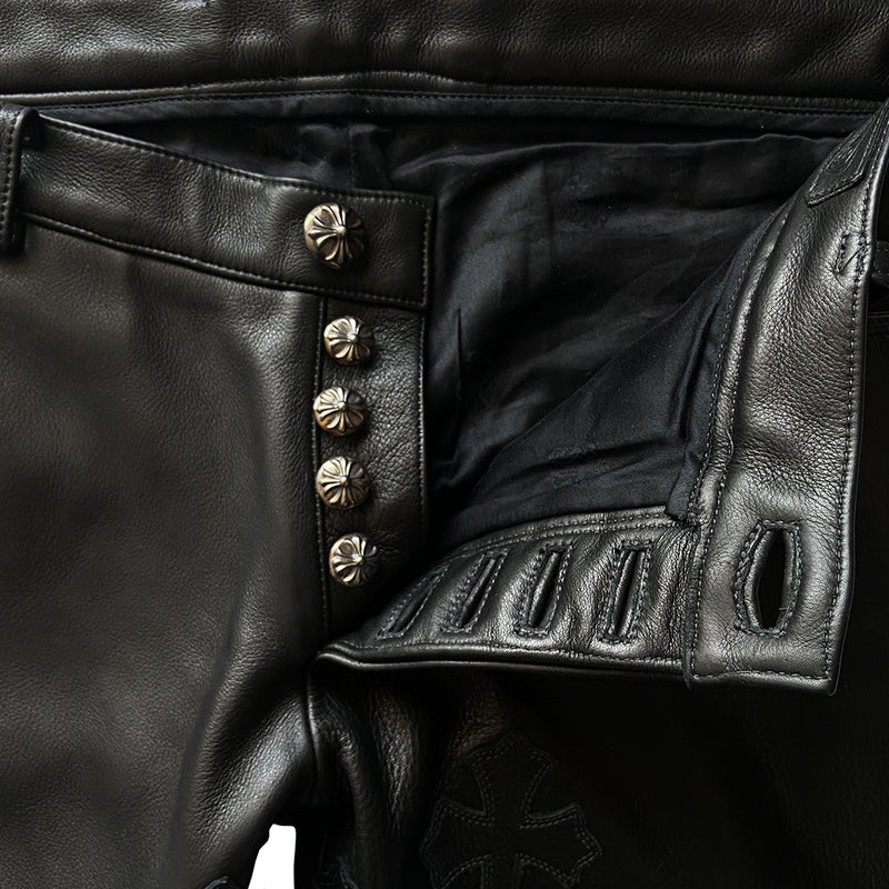 Custom-made unused black leather pants by Chrome Hearts, Los Angeles Front CH appliqué fleur du lis patch at front knees. 5 cross patches, Chrome Hearts jacquard silk lining, 5 sterling silver fly buttons. Three front pockets with sterling grommets, back pocket with sterling Chrome Hearts banner, Interior leather Chrome Hearts USA banner embossed patch. 