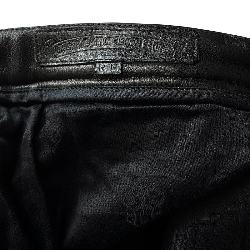 Custom-made unused black leather pants by Chrome Hearts, Los Angeles Front CH appliqué fleur du lis patch at front knees. 5 cross patches, Chrome Hearts jacquard silk lining, 5 sterling silver fly buttons. Three front pockets with sterling grommets, back pocket with sterling Chrome Hearts banner, Interior leather Chrome Hearts USA banner embossed patch. 