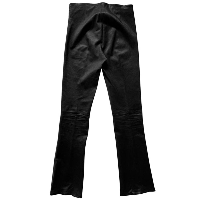 Butter soft women’s boot cut leather pants with CH appliqué signature fleur de lis at front knees. Faux front slash pockets, zip fly closure with signature dagger zipper pull and sterling cross top button. Chrome Hearts USA banner embossed leather patch at interior waist. Made in USA 