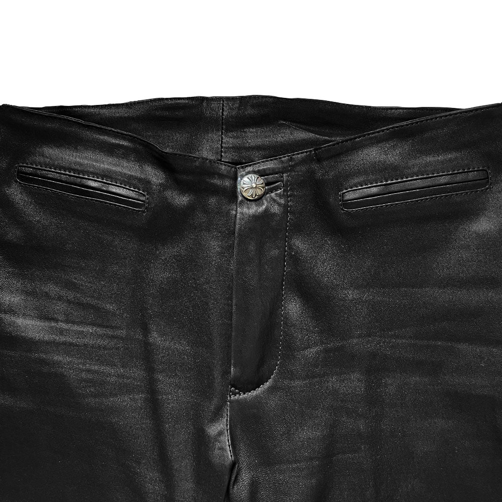 Butter soft women’s boot cut leather pants with CH appliqué signature fleur de lis at front knees. Faux front slash pockets, zip fly closure with signature dagger zipper pull and sterling cross top button. Chrome Hearts USA banner embossed leather patch at interior waist. Made in USA 