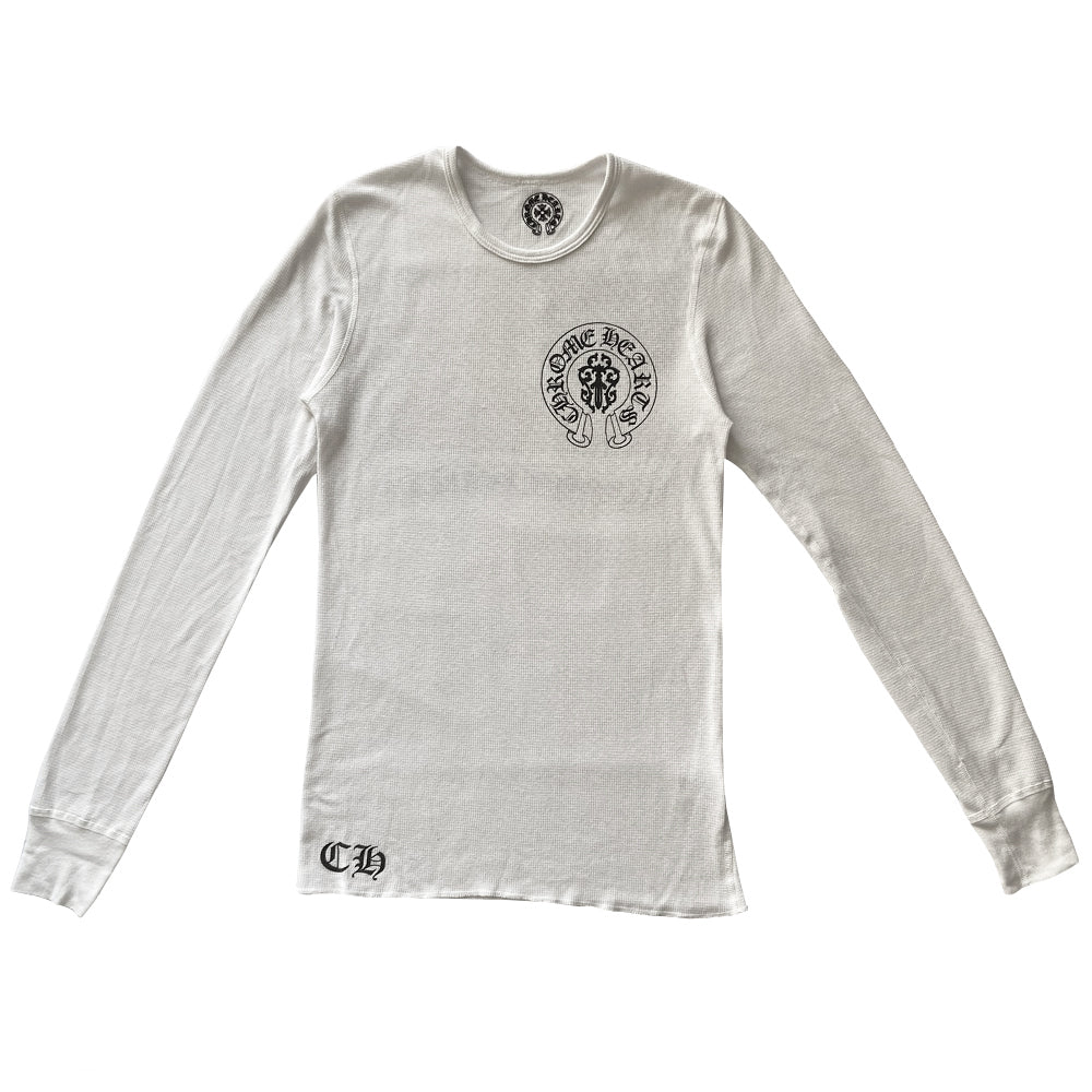 Chrome Hearts white cross thermal knit long sleeve tee with dagger design inside Chrome Hearts horseshoe logo at chest, CH at bottom front hemline, Chrome Hearts emblem and tiny daggers, red, white, blue American flag with surrounding crosses accent and logo scroll underneath. Made in USA