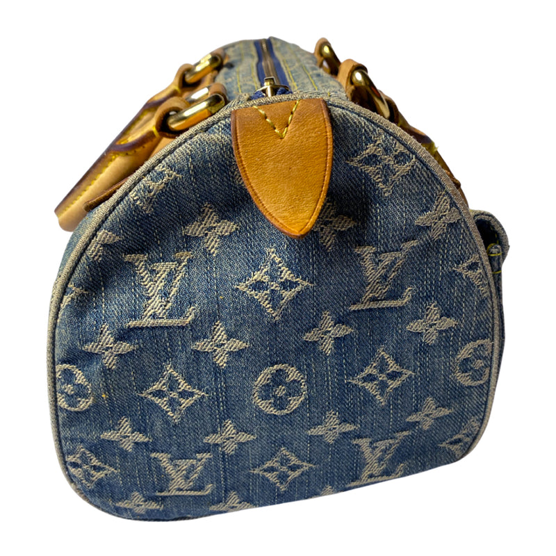 Louis Vuitton monogram blue denim neo speedy by Marc Jacobs for Louis Vuitton, 2005 with 2 outer front pockets with gold-tone push lock closures and hardware. Vachetta leather trimmed exterior, zippered outer pocket, 2 rolled leather handles. Top zip closure opens to alcantara lining with one interior slip pocket. Made in France