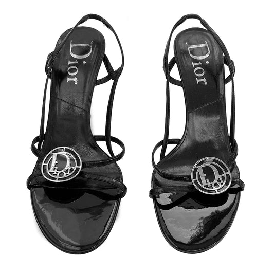 Christian Dior Logo Medallion Strappy Sandals with slip on style heel strap elastic in back and open toe Silver and black curved metal logo medallion embellishment in front. Reconditioned sole, excellent condition. Material: Patent Leather upper Color: black. Size: 40 Made in Italy 