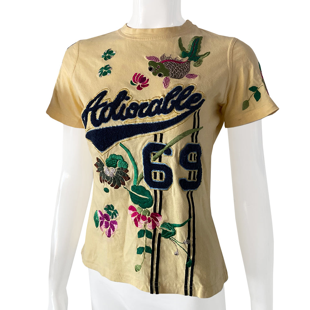 Christian Dior Adiorable 69 short sleeve yellow tee by John Galliano for Christian Dior, FW 2003 with Adiorable 69 front and back appliqué and green, pink, fuchsia  embroidered flowering fuchsia plants, koi and lily pads in front, flowers on sleeve, 2 stripes on the other.  Size: FR 42 Made in Italy 