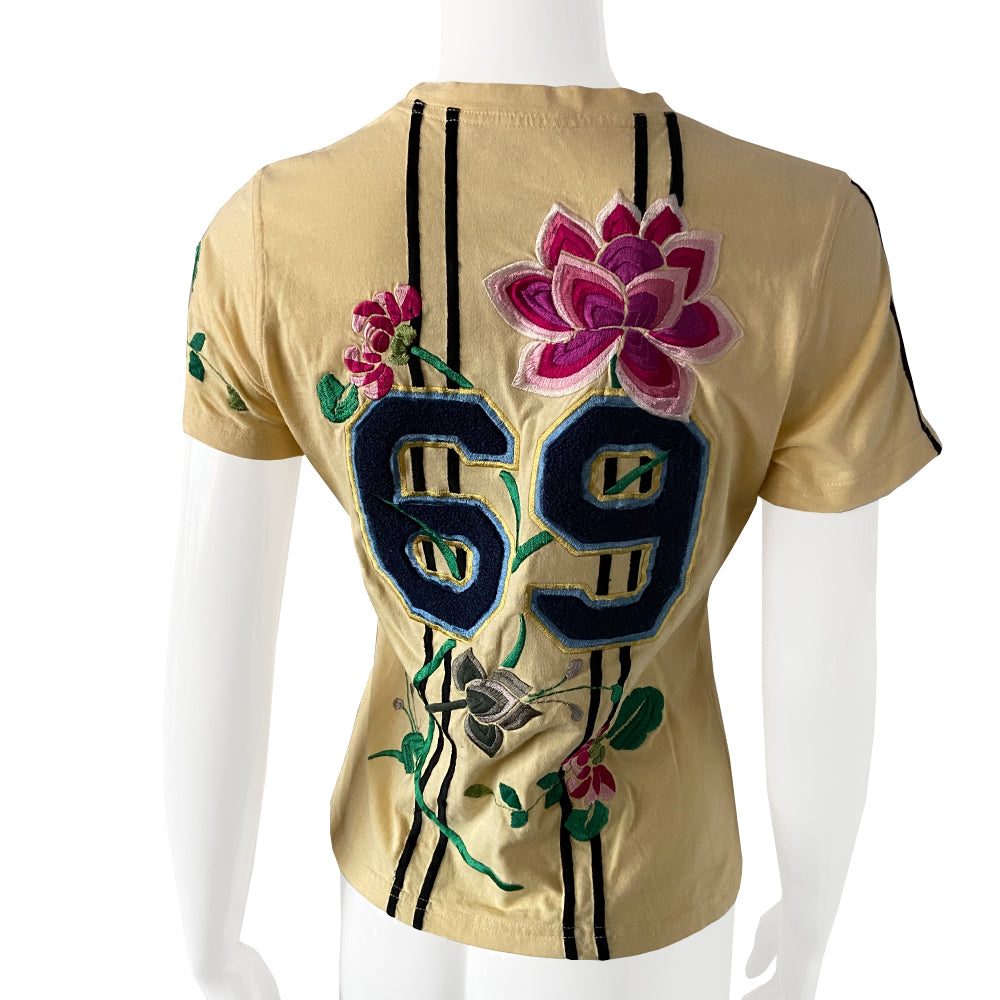 Christian Dior Adiorable 69 short sleeve yellow tee by John Galliano for Christian Dior, FW 2003 with Adiorable 69 front and back appliqué and green, pink, fuchsia  embroidered flowering fuchsia plants, koi and lily pads in front, flowers on sleeve, 2 stripes on the other.  Size: FR 42 Made in Italy 