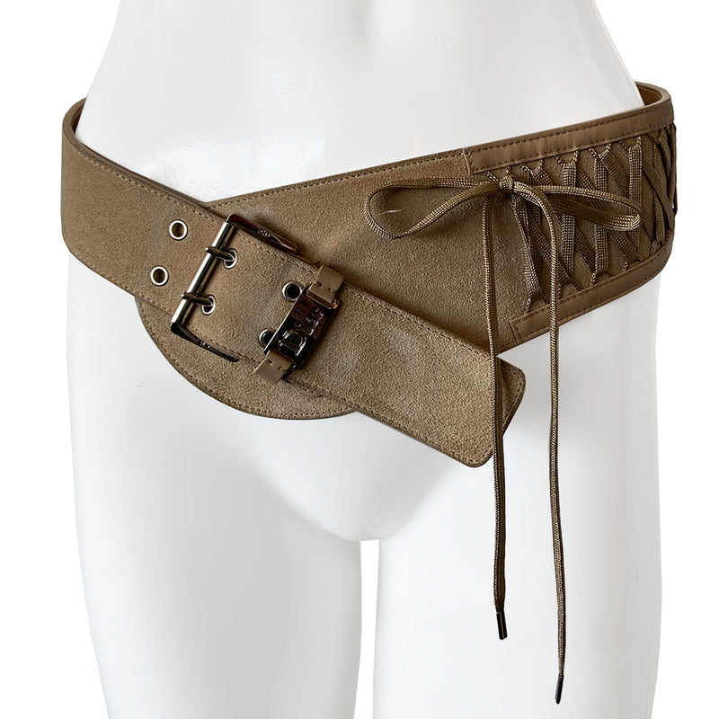 Christian Dior Suede Admit It lace-up corset belt in soft tan color from Autumn 2002 RTW collection by John Galliano. Criss-cross lace up detail with woven corset laces with silver aglet-tipped ends. Silver-tone double pronged buckle and Dior logo plate at front with adjustable sizing. Made in Italy 