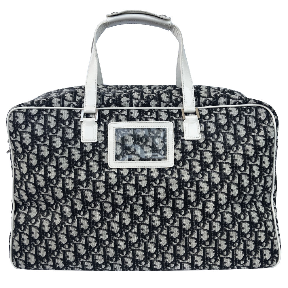 Christian Dior black monogram canvas large travel tote by John Galliano for Dior, 2001 runway. White patent leather flat handles, piping, accent No 1 with 2 accent stripes in front. Small back ID slotted window. Silver-tone zipper and hardware opens to black satin fabric lining with one zip pocket and snap closure slip pockets. Made in Italy 