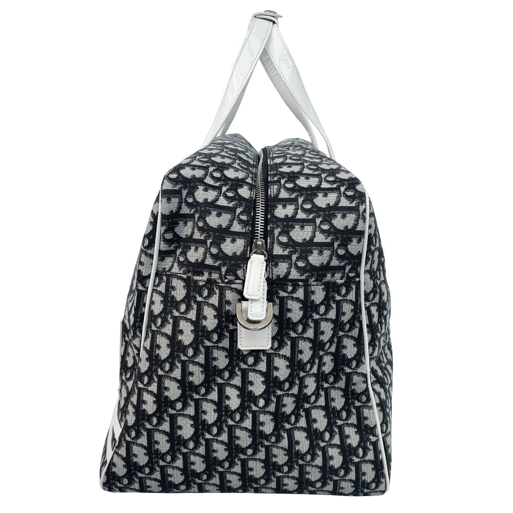 Christian Dior black monogram canvas large travel tote by John Galliano for Dior, 2001 runway. White patent leather flat handles, piping, accent No 1 with 2 accent stripes in front. Small back ID slotted window. Silver-tone zipper and hardware opens to black satin fabric lining with one zip pocket and snap closure slip pockets. Made in Italy 