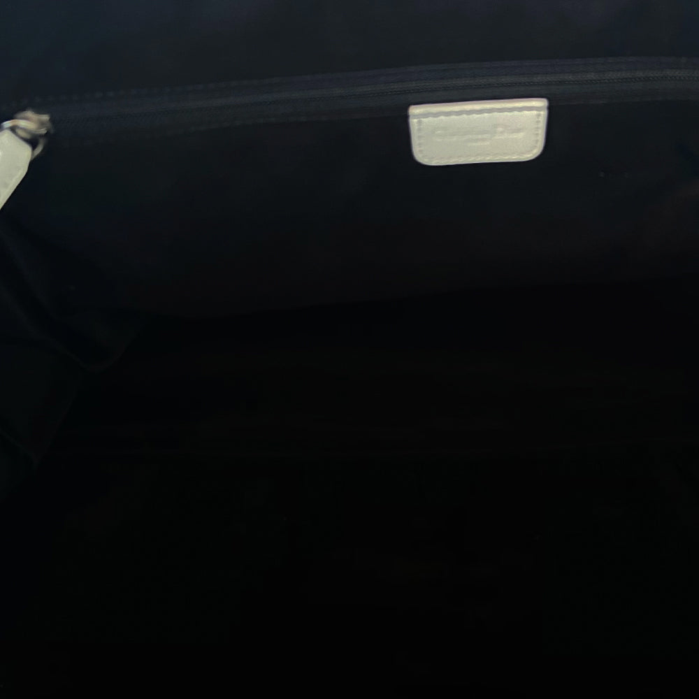 Christian Dior black monogram canvas large travel tote by John Galliano for Dior, 2001 runway. White patent leather flat handles, piping, accent No 1 with 2 accent stripes in front. Small back ID slotted window. Silver-tone zipper and hardware opens to black satin fabric lining with one zip pocket and snap closure slip pockets. Made in Italy 