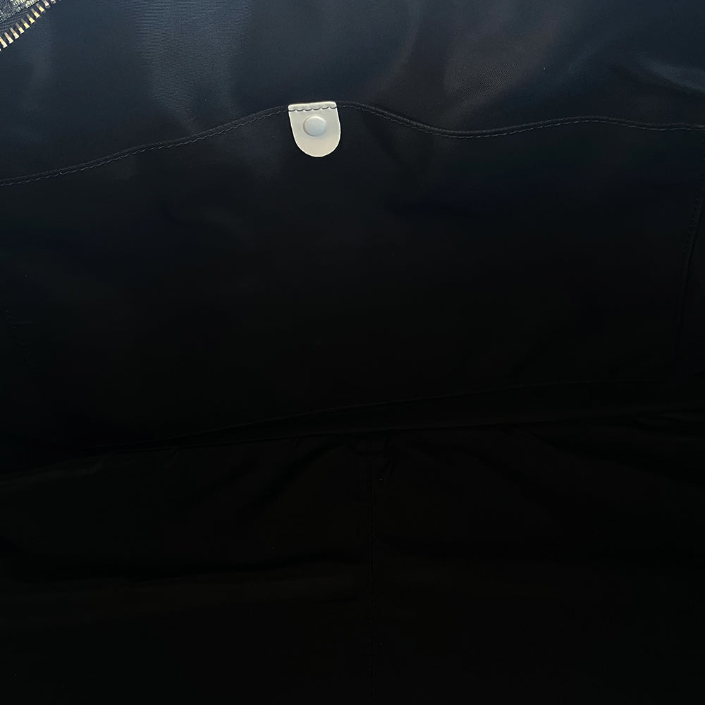 Christian Dior black monogram canvas large travel tote by John Galliano for Dior, 2001 runway. White patent leather flat handles, piping, accent No 1 with 2 accent stripes in front. Small back ID slotted window. Silver-tone zipper and hardware opens to black satin fabric lining with one zip pocket and snap closure slip pockets. Made in Italy 