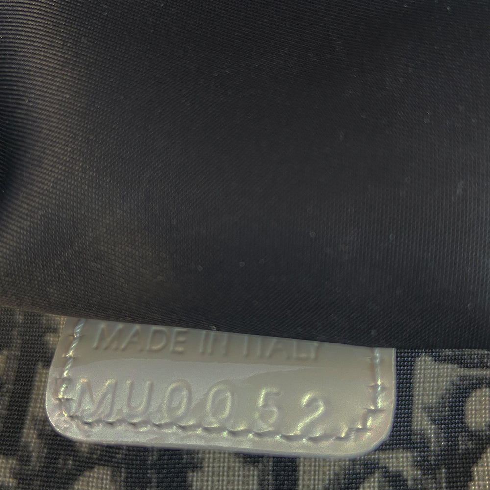 Christian Dior black monogram canvas large travel tote by John Galliano for Dior, 2001 runway. White patent leather flat handles, piping, accent No 1 with 2 accent stripes in front. Small back ID slotted window. Silver-tone zipper and hardware opens to black satin fabric lining with one zip pocket and snap closure slip pockets. Made in Italy 
