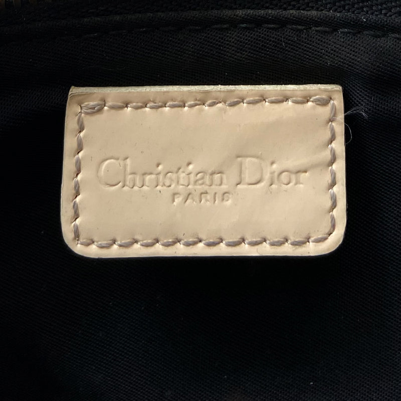 Christian Dior black Diorissimo monogram canvas mini saddle bag by John Galliano for Dior 2001 with cream leather piping and strap, silver-tone hardware. Leather strap unclips at one end that loops to carry wristlet style. Zip closure with Dior embossed leather zipper pull, black textile interior. Made in Spain 