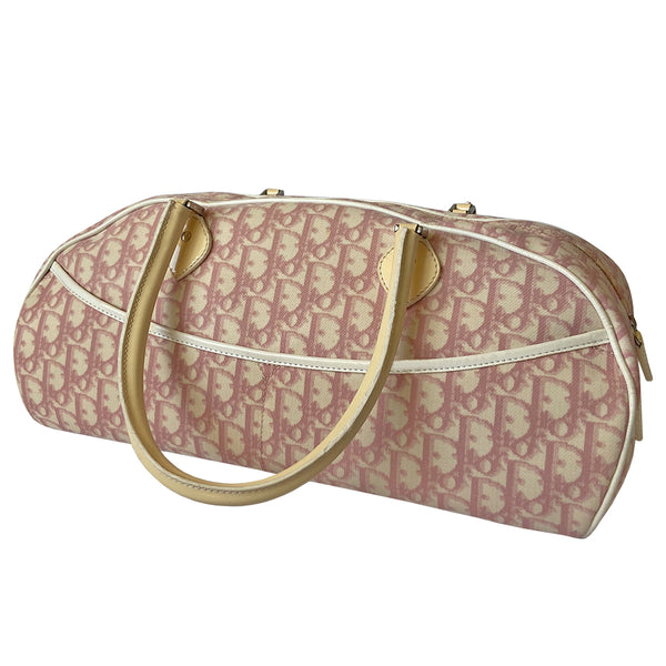 Christian Dior large pink monogram canvas boston by John Galliano for Dior, 2004 with white leather piping, cream patent leather accent trim, rolled handles and zipper pull, silver-tone hardware and feet. 2 exterior open pockets with leather accent, pink textile interior with one interior zip pocket, 2 slip pockets. 