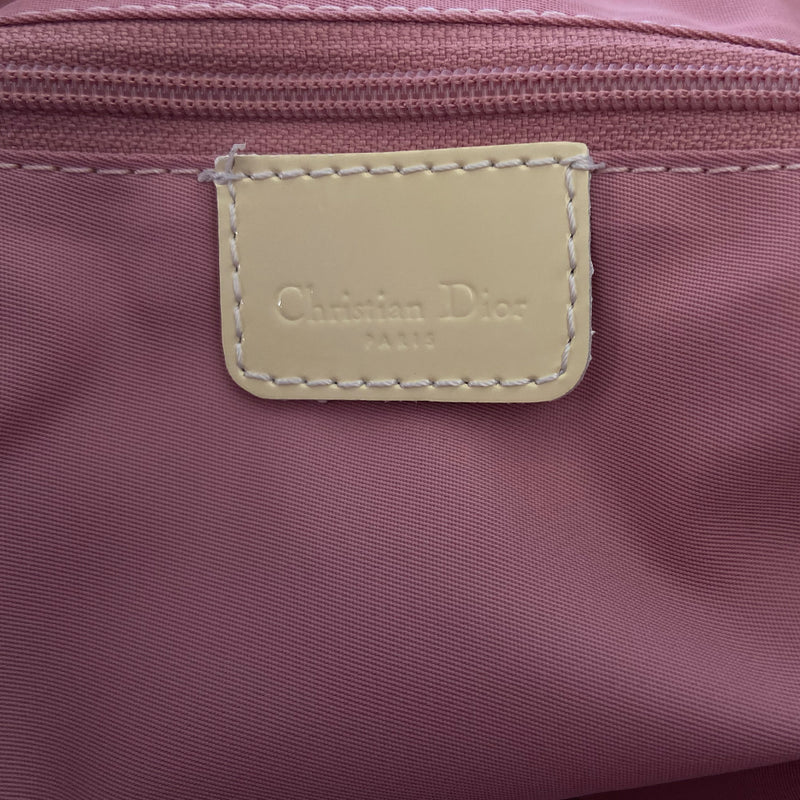 Christian Dior large pink monogram canvas boston by John Galliano for Dior, 2004 with white leather piping, cream patent leather accent trim, rolled handles and zipper pull, silver-tone hardware and feet. 2 exterior open pockets with leather accent, pink textile interior with one interior zip pocket, 2 slip pockets. 