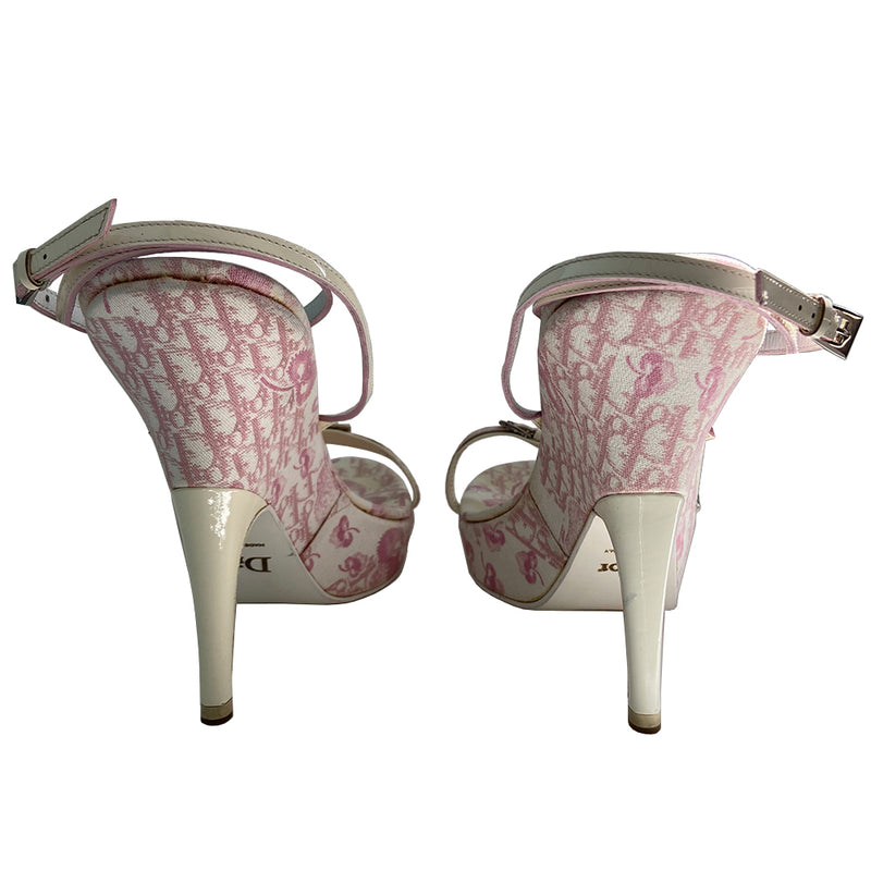 Christian Dior pink cherry blossom monogram on white open toe sandals from John Galliano spring 2003 featuring pink floral monogram with cherry blossom canvas soles, white patent leather heels and wrap around ankle straps. Silver chain and buckle detail layered on upper monogram strap edged with patent leather. Made in Italy 