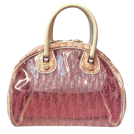 Christian Dior pink monogram Rain bowler bag by John Galliano for Dior, 2004 with transparent vinyl and canvas body, 2 rolled white patent handles and piping, silver-tone hardware, domed bottom feet. Dual zippers opening, roomy pink textile partial lining. Includes pink monogram removable interior pouch. Made in Italy 