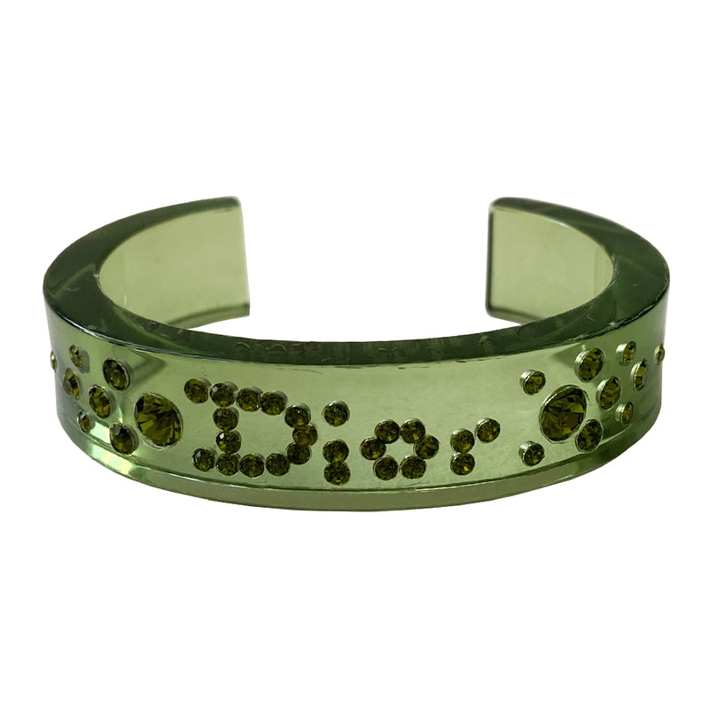 Christian Dior narrow green lucite crystal cuff with Dior spelled out in embedded brilliant green crystals. 