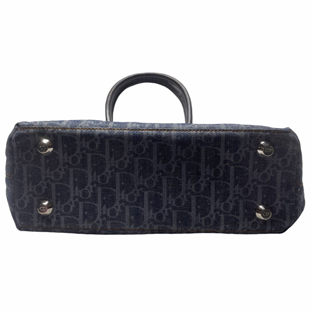 John Galliano for Dior, 2004 navy Diorissimo denim with orange contrast stitching, orange band, silver CD stamped D clasp hardware. Top zip with one interior pocket and navy nylon lining. Made in Italy