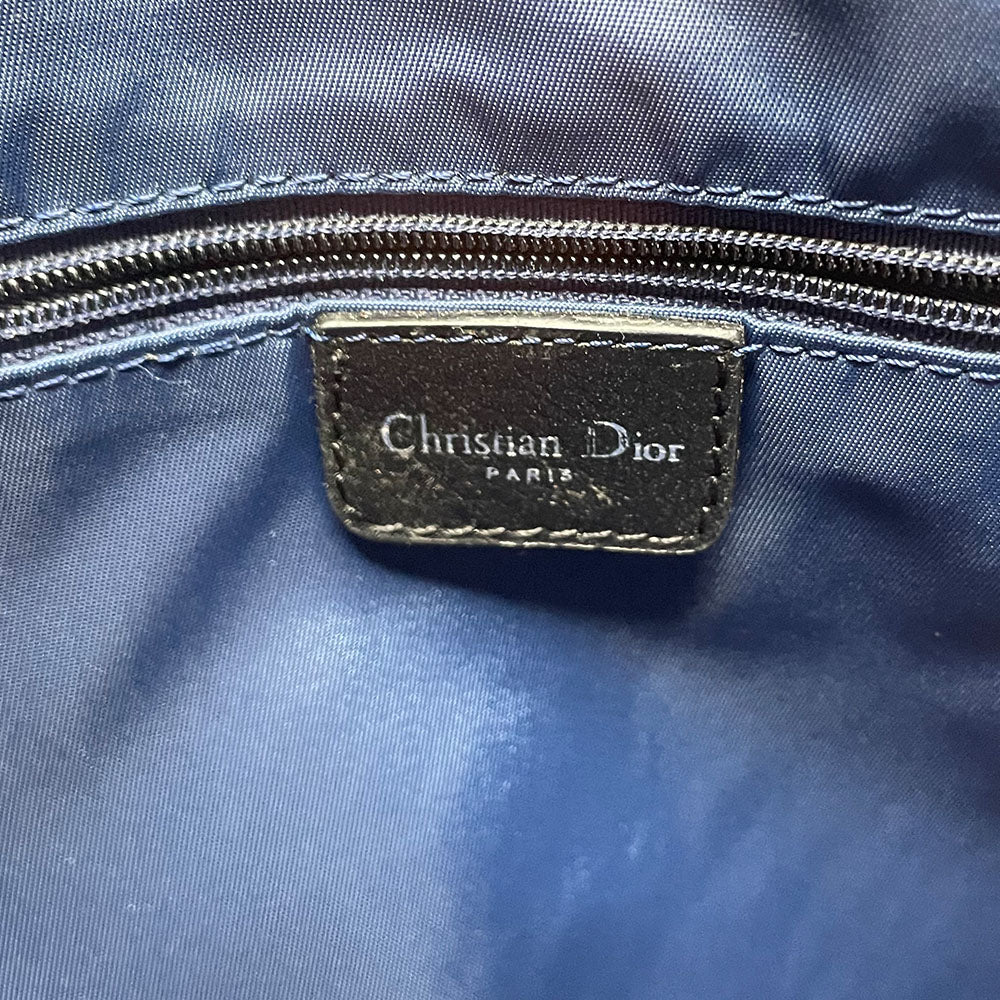 John Galliano for Dior, 2004 navy Diorissimo denim with orange contrast stitching, orange band, silver CD stamped D clasp hardware. Top zip with one interior pocket and navy nylon lining. Made in Italy