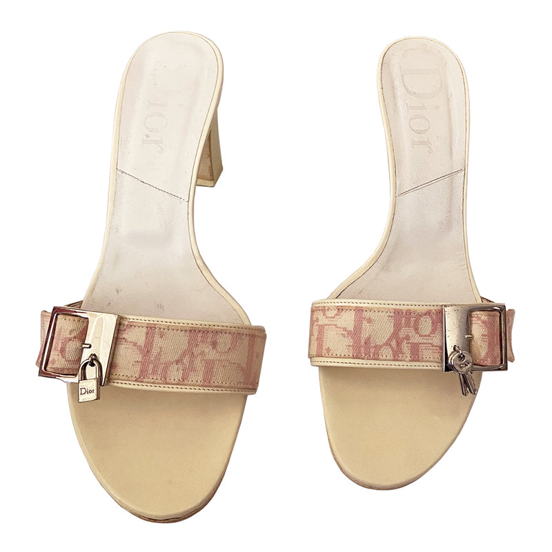 Christian Dior slides heels by John Galliano for Dior, 2003. Pink Diorissimo canvas slip-on open toe block heel sandals with silver-tone buckle at top strap, lock on one shoe and key on the other. White patent leather heels and accent. Made in Italy 
