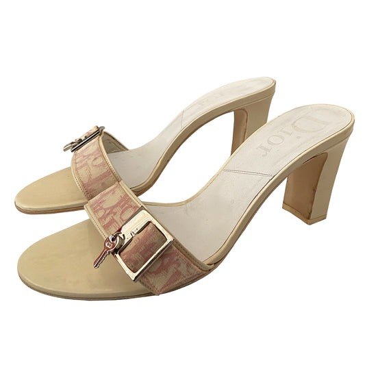 Christian Dior slides heels by John Galliano for Dior, 2003. Pink Diorissimo canvas slip-on open toe block heel sandals with silver-tone buckle at top strap, lock on one shoe and key on the other. White patent leather heels and accent. Made in Italy 