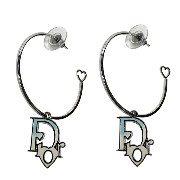 Christian Dior silver-tone logo hoop earrings with, open heart design at one end, dangling Dior logo feature with blue ombre accent. Clutch back closure. 