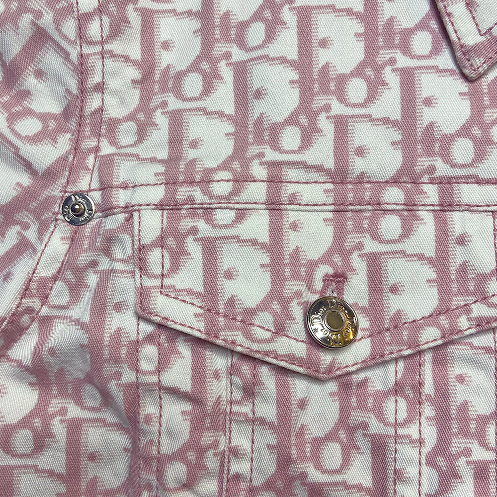 Christian Dior pink monogram Girly button up denim jacket by John Galliano for Dior, spring 2004 with 2 front flap pockets at chest and No 1 surrounded by Swarovski crystals. Silver-tone logo buttons and engraved logo buckle details on adjustable side straps, Dior crystal logo at one sleeve cuff. Made in Portugal 