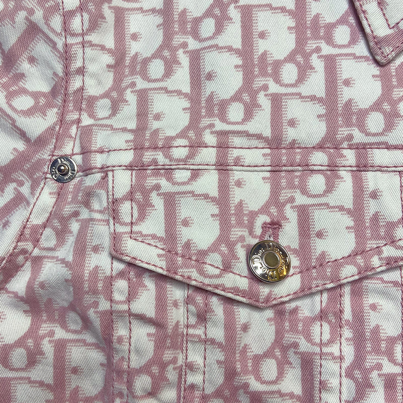 Christian Dior pink monogram Girly button up denim jacket by John Galliano for Dior, spring 2004 with 2 front flap pockets at chest and No 1 surrounded by Swarovski crystals. Silver-tone logo buttons and engraved logo buckle details on adjustable side straps, Dior crystal logo at one sleeve cuff. Made in Portugal 