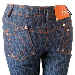Christian Dior Flight Collection monogram indigo blue denim pants from John Galliano for Dior 2005 collection. Mid-rise 5 pocket Diorissimo print denim with orange accent stitching, angled rear pockets with signature D in orange stitching, Dior engraved logo silver rivets and 3 logo button front closure. Silver-one metal engraved Christian Dior CD buttons, orange Dior patch in back. t