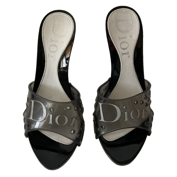 Christian Dior black jelly platform slides by John Galliano for Christian Dior circa 2000. Silver-tone Dior logo on clear black jelly upper with air holes. Glossy black platform and heels with silver-tone side studs. Leather insole stamped with Dior logo at heel. Rubber DIOR stamped bottom soles. Made in Italy 
