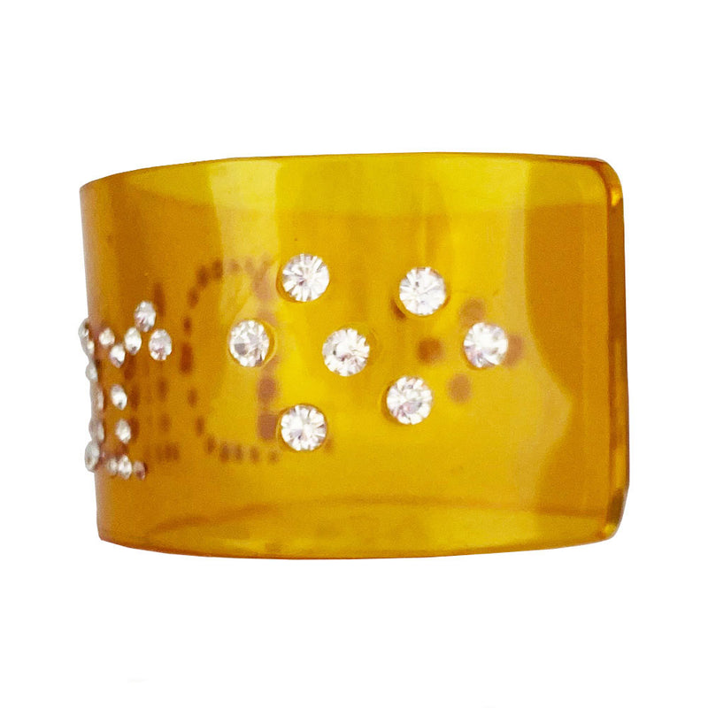 Christian Dior clear yellow lucite wide cuff bangle with Dior spelled out in white crystals.  