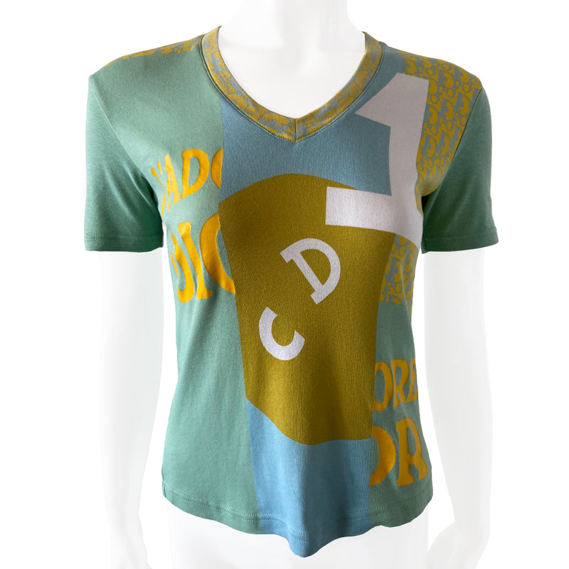 Christian Dior J’Adore Dior short sleeve V neck spring 2005 runway patchwork tee from Japan featuring a patchwork of iconic John Galliano for Dior logo designs through the years Fabric: 100% cotton.  Color: Main: Turquoise and blue Fabric: 100% cotton Size: FR 38 Made in Portugal 