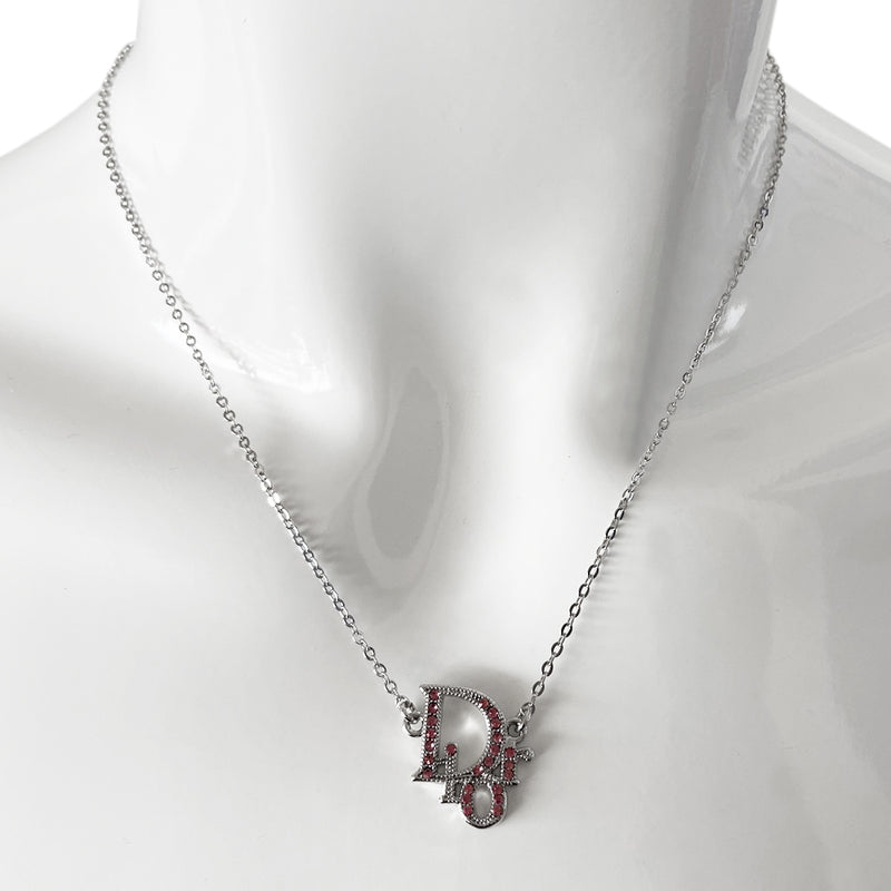 Christian Dior pink crystal embellished Dior Logo necklace with silver-tone chain attached to crystal embellished Dior logo charm with lobster back closure and tiny Dior engraved hanging logo D charm in back 