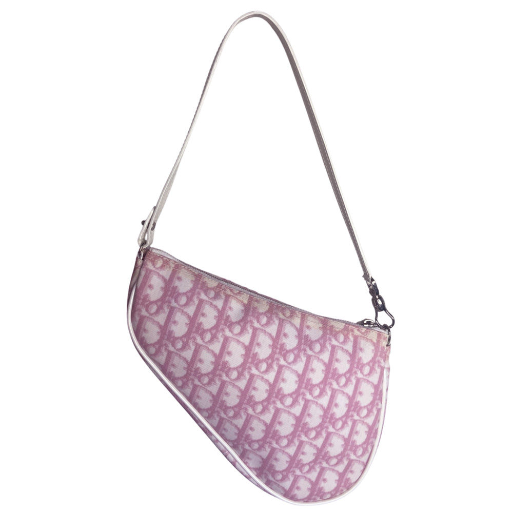 Christian Dior pink canvas monogram mini saddle pochette by John Galliano for Dior 2004 with white patent leather piping and strap, silver-tone hardware. Leather strap unclips at one end and can be looped to carry wristlet style. Top zipper closure with  pink textile interior. Duster and card included. Made in Spain 