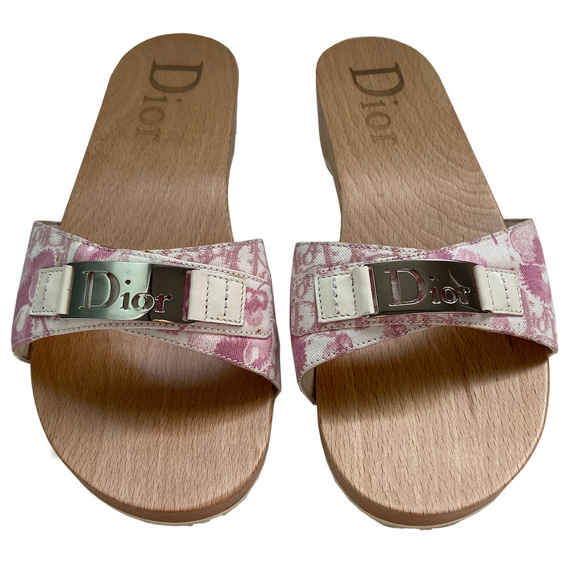Christian Dior Girly Diorissimo floral slide Sandals, 2004 by John Galliano for Christian Dior. Pink and creme Diorissimo printed canvas upper features silver-tone cutout Dior logo plate,  ivory patent and silver-tone side studs. Dior logo stamped into wood sole with white rubber bottom DIOR logo stamped lower soles. 