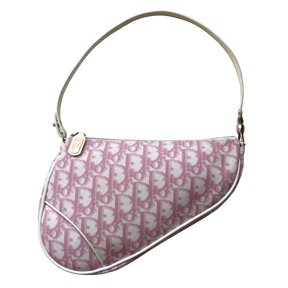 Christian Dior pink Diorissimo canvas saddle Bag John Galliano for Dior 2004.  Diorissimo canvas saddle pochette with white leather piping and strap, silver-tone hardware. Leather strap unclips at one end that loops to carry wristlet style. Zip closure with Dior embossed leather zipper pull, pink textile interior. Made in Spain 