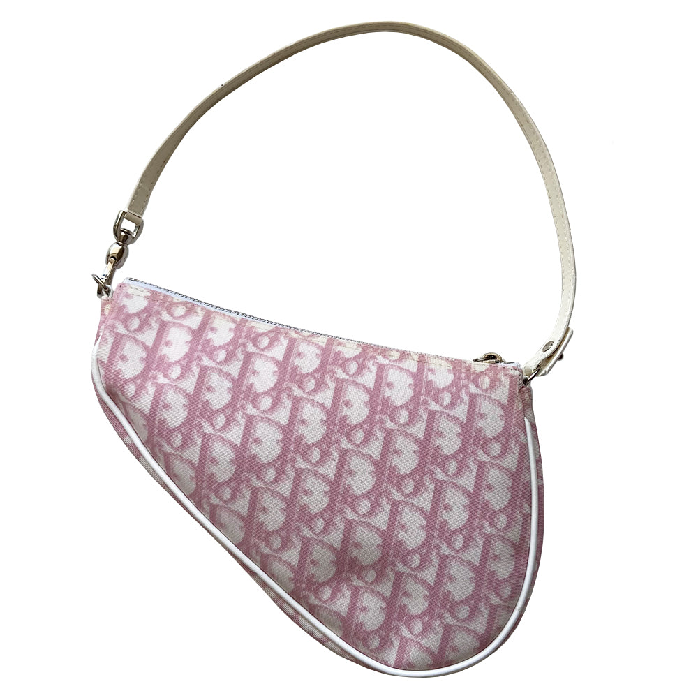 Christian Dior pink Diorissimo canvas saddle Bag John Galliano for Dior 2004.  Diorissimo canvas saddle pochette with white leather piping and strap, silver-tone hardware. Leather strap unclips at one end that loops to carry wristlet style. Zip closure with Dior embossed leather zipper pull, pink textile interior. Made in Spain 