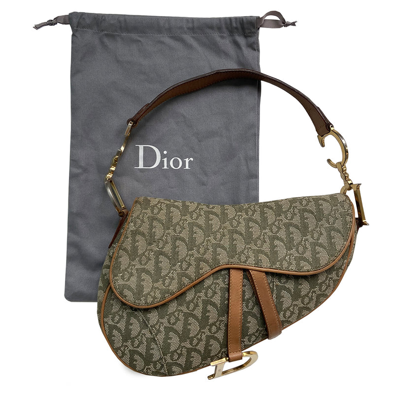 Christian Dior green diorissimo  monogram canvas saddle bag, John Galliano for Dior 2001 with gold-tone hardware, caramel leather. Single flat top leather handle featuring CD side logos. Velcro front closure at flap with front gold D logo. Rear slip snap pocket. Interior tonal nylon lining with single zip pocket. 